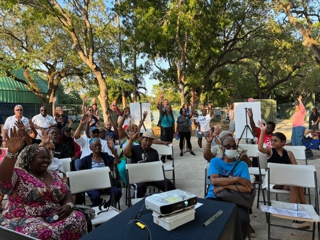 May 29th, 2024 Virrick Park Pool Community Meeting. Photo of attendees watching the presentation being given by the designer.