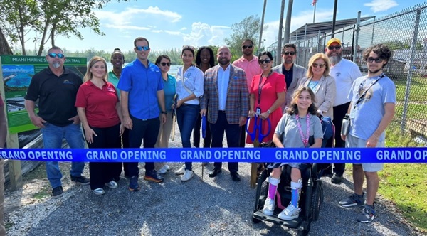 Photo of District 2 Commissioner, Damian Pardo, and City of Miami Staff about to cut the ribbon at the grand opening of the Virginia Key Basin Trail. 